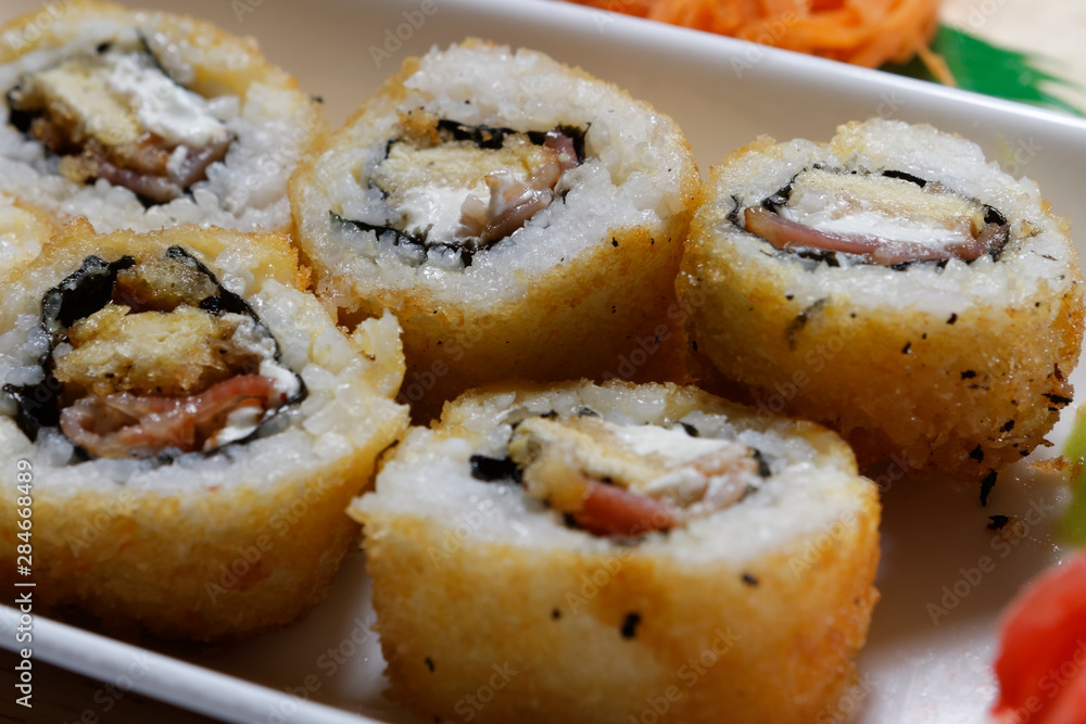 Sushi is traditionally made with medium-grain white rice. It is very often prepared with seafood, such as squid, eel, yellowtail, salmon, tuna or imitation crab meat. Sushi is traditionally made with medium-grain white rice. It is very often prepared with seafood, such as squid, eel, yellowtail, salmon, tuna or imitation crab meat.