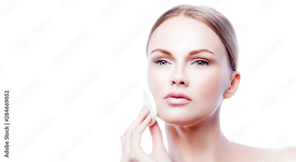 Beauty face of fashion model woman copy space. Blond hair style, perfect skin, apply cosmetics cream with cotton pad. White background. Isolated Beauty face of fashion model woman copy space. Blond hair style, perfect skin, apply cosmetics cream with cotton pad. White background. Isolated