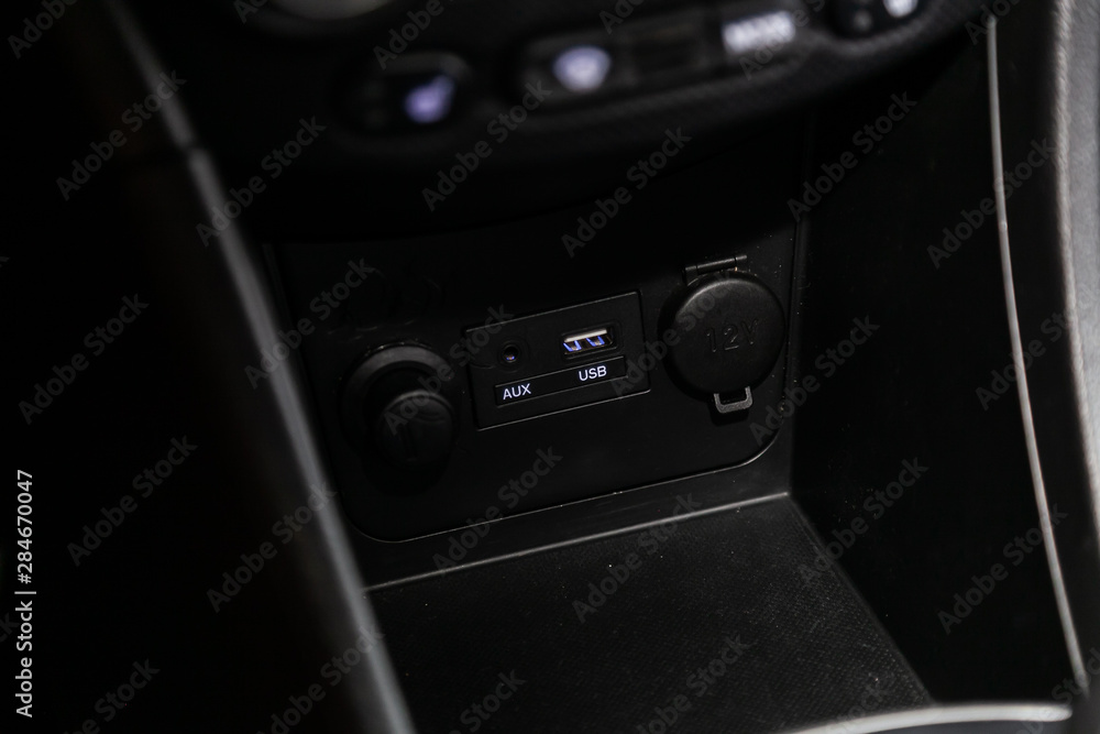 Close up of a charging in the car, cigarette lighter, aux, usb connectors. modern car interior. Close up of a charging in the car, cigarette lighter, aux, usb connectors. modern car interior.