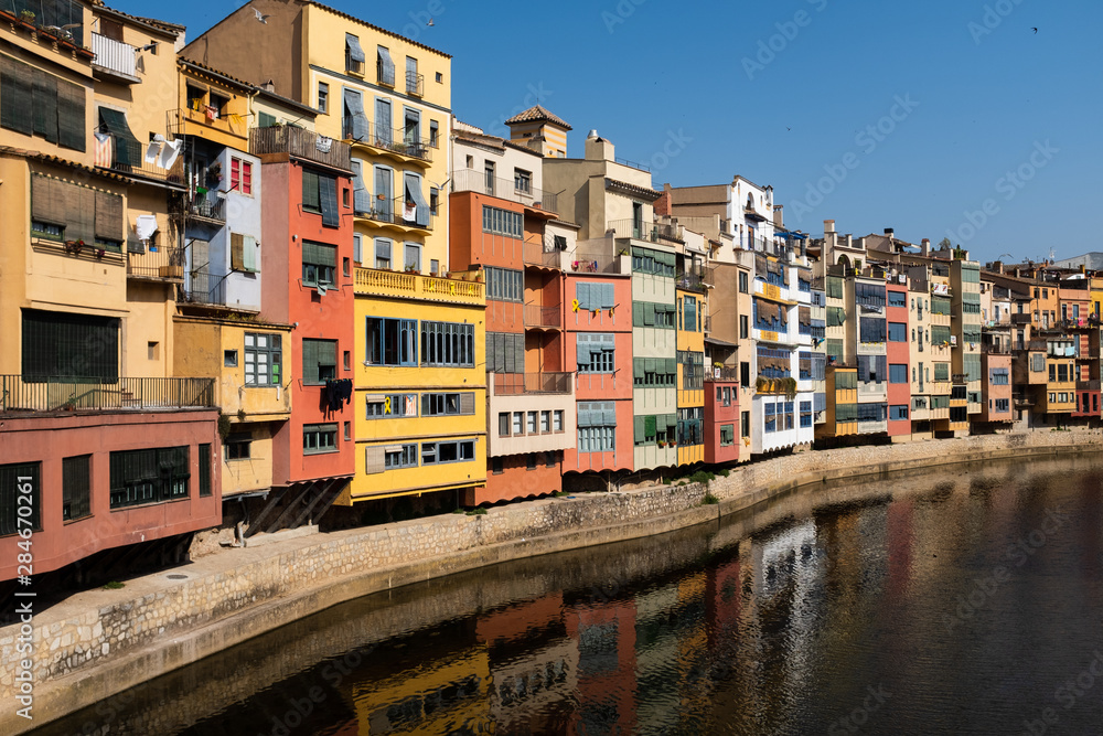 The brightly painted facades of the houses looking over the River Onyar in the ancient centre of Gerona.