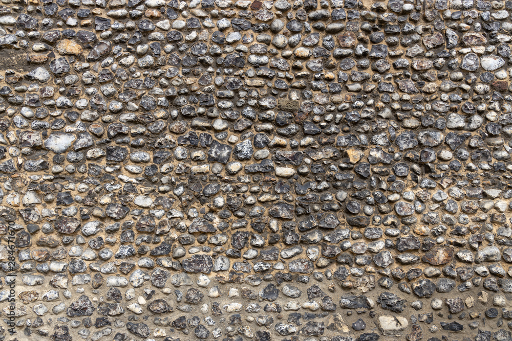 Layered flint pebble stone wall texture graphic resource