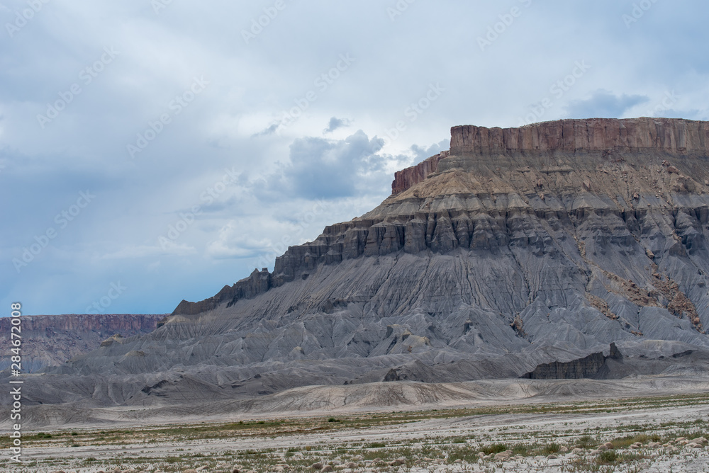 Fototapeta premium Landscape of blue, grey and yellow barren hills near Hanksville, Utah