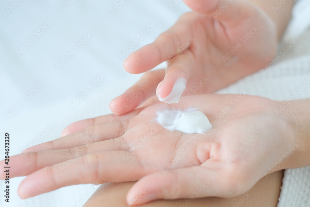 Woman applying moisturizing cream/lotion on hands, beauty concept. Woman applying moisturizing cream/lotion on hands, beauty concept.