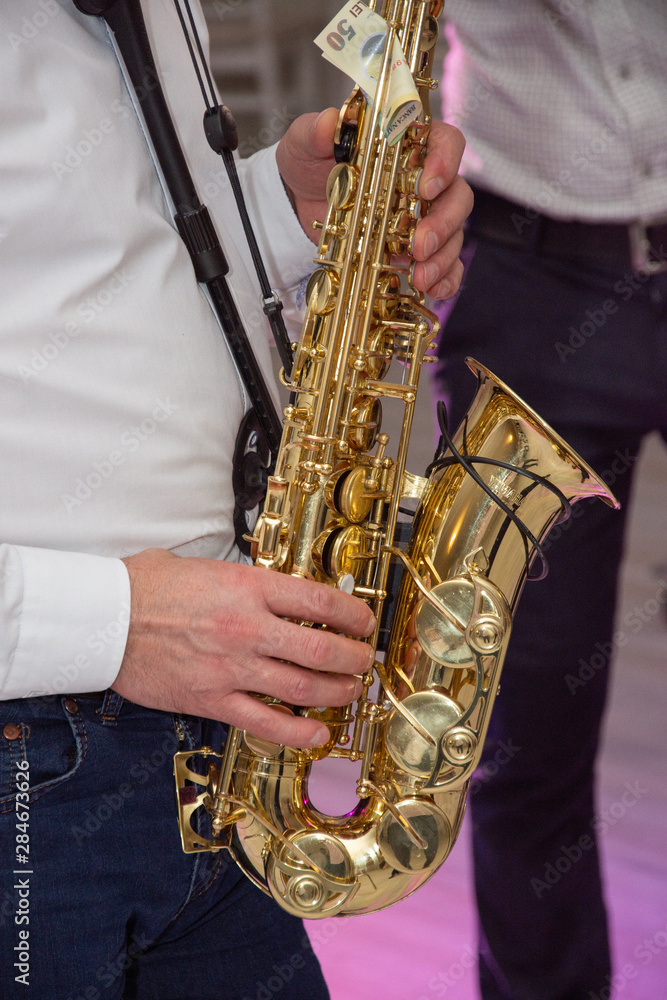 Naklejka premium Man plays the saxophone