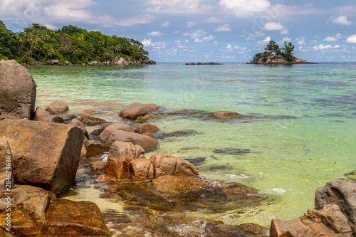 Paradise beach anse royale on Seychelles island Mahé with turguoise water, palms, white sand and granite rocks photo