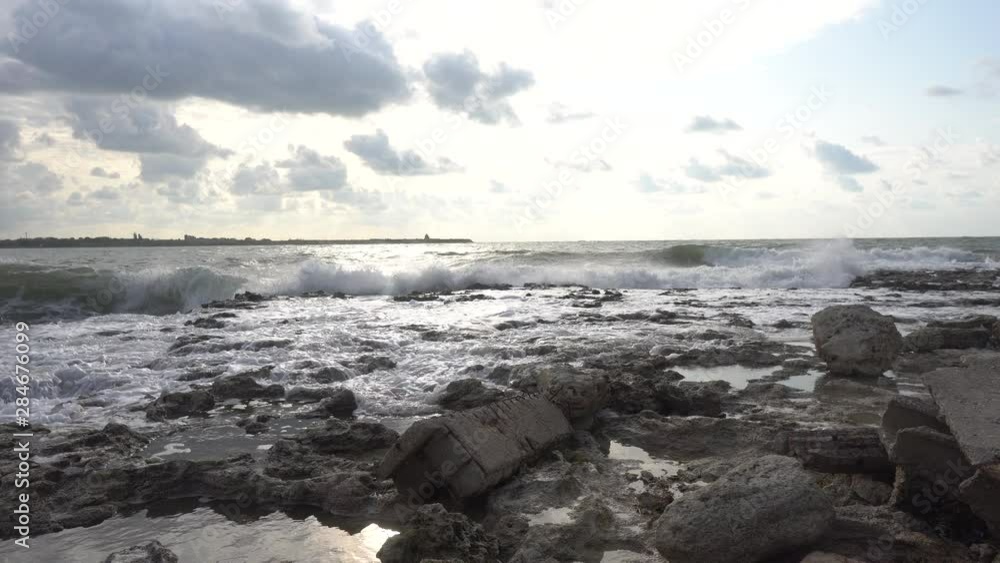 Surf on the sea. Waves breaking, crushing and splashing on the rocks and reefs on sea coast. Rolling waves on ocean at summer. Surf on the sea. Waves breaking, crushing and splashing on the rocks and reefs on sea coast. Rolling waves on ocean at summer.