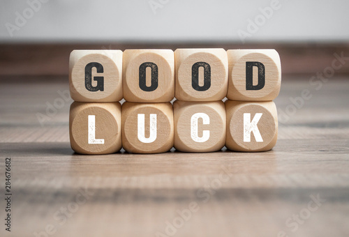 Cubes and dice with good luck on wooden background photo