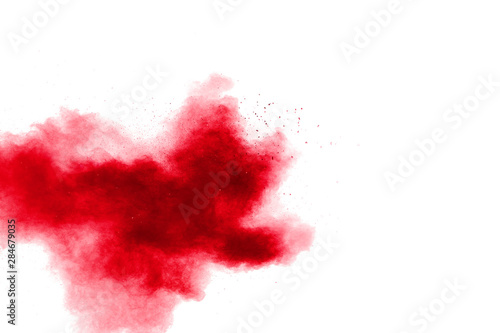Abstract red powder explosion on white background. Red powder explosion.Freeze motion of red dust particles splash.