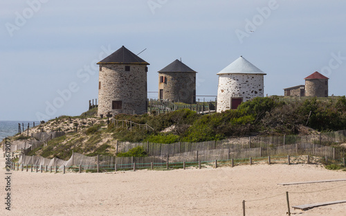 Ancient Windmills in Apulia Beach, Portugal. photo