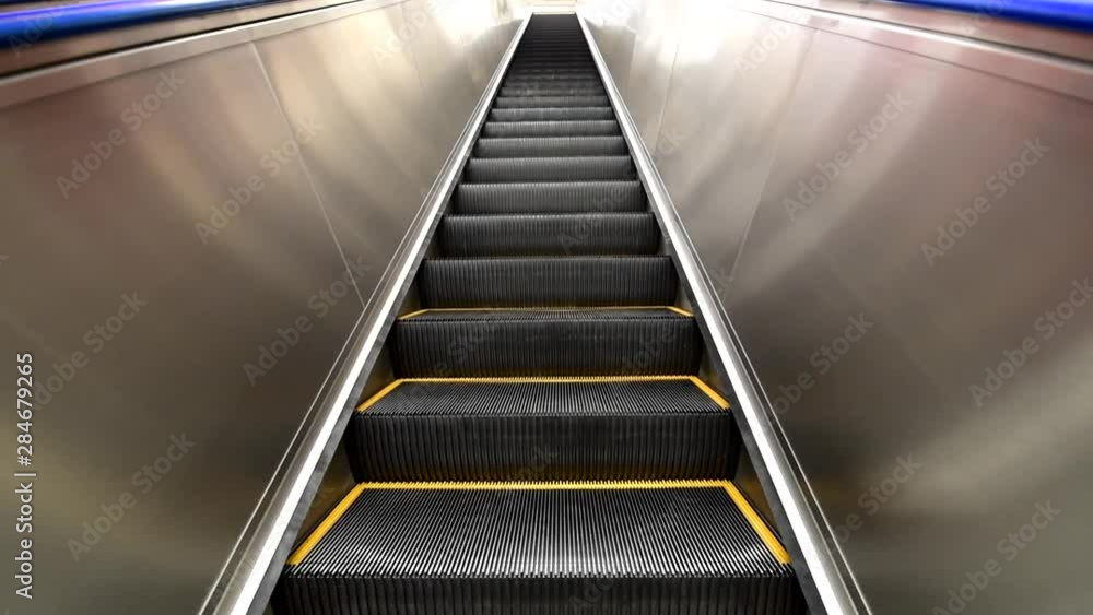 Standing on Outdoor escalator for moving in building Standing on Outdoor escalator for moving in building