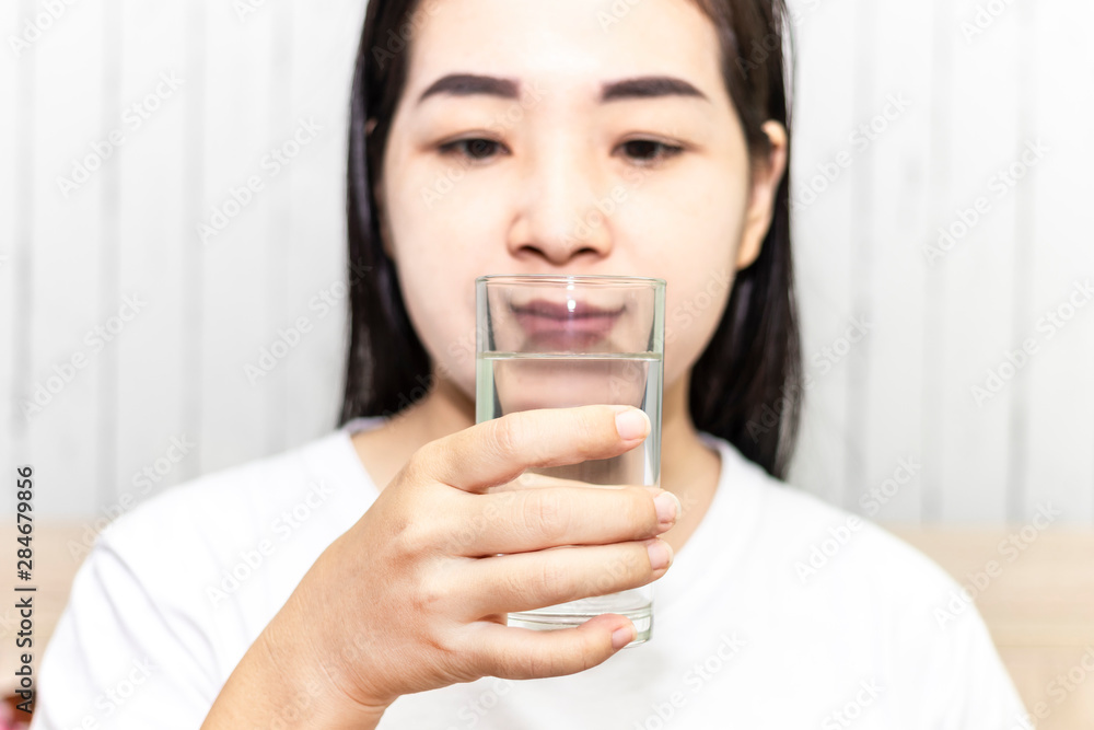 Cute asian young woman drink water from glass. Beautiful young girl hand holding drinking water. Cute asian young woman drink water from glass. Beautiful young girl hand holding drinking water.
