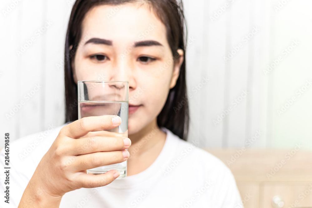 Cute asian young woman drink water from glass. Beautiful young girl hand holding drinking water. Cute asian young woman drink water from glass. Beautiful young girl hand holding drinking water.