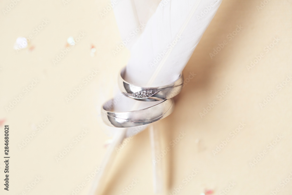 beautiful macro shot of golden wedding ring with some stuff on colored background beautiful macro shot of golden wedding ring with some stuff on colored background