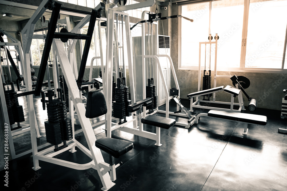 Fototapeta premium Within gym with modern fitness equipment.