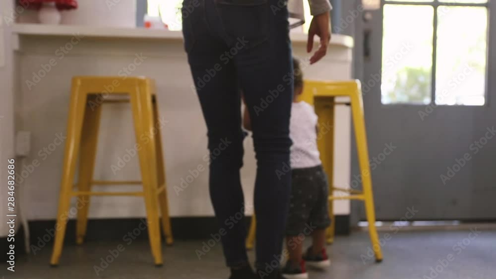Mom and baby walking into café Mom and baby walking into café
