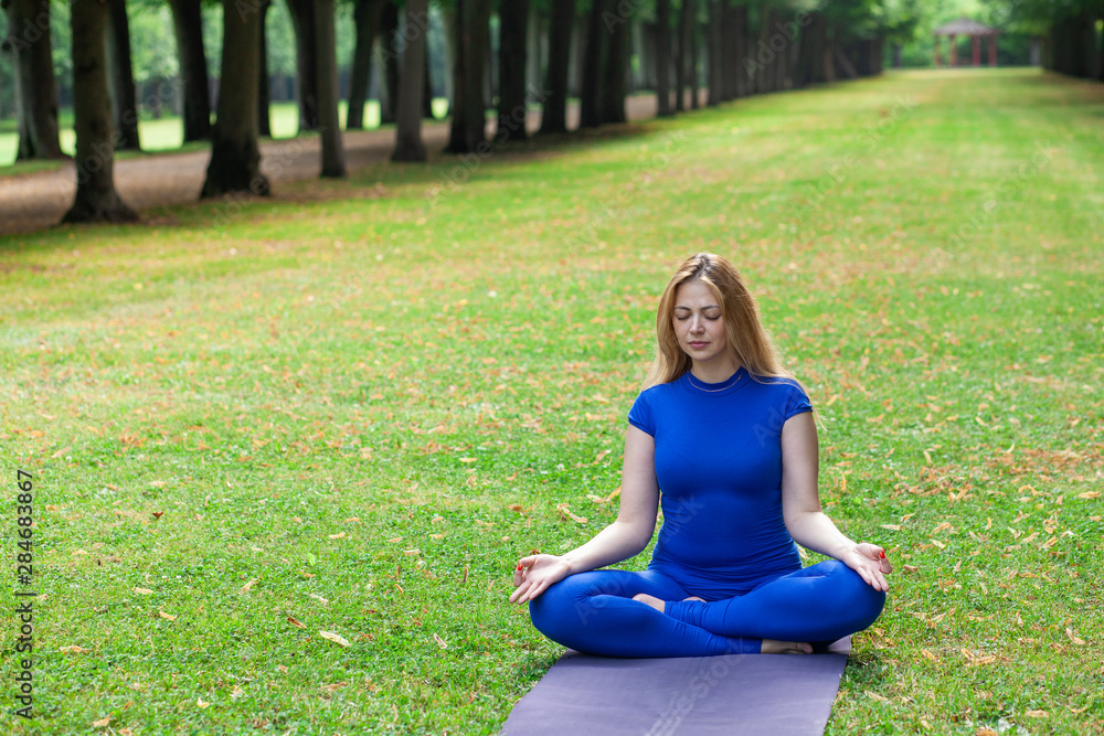 White girl in a city park in the morning doing yoga, copy space, text White girl in a city park in the morning doing yoga, copy space, text