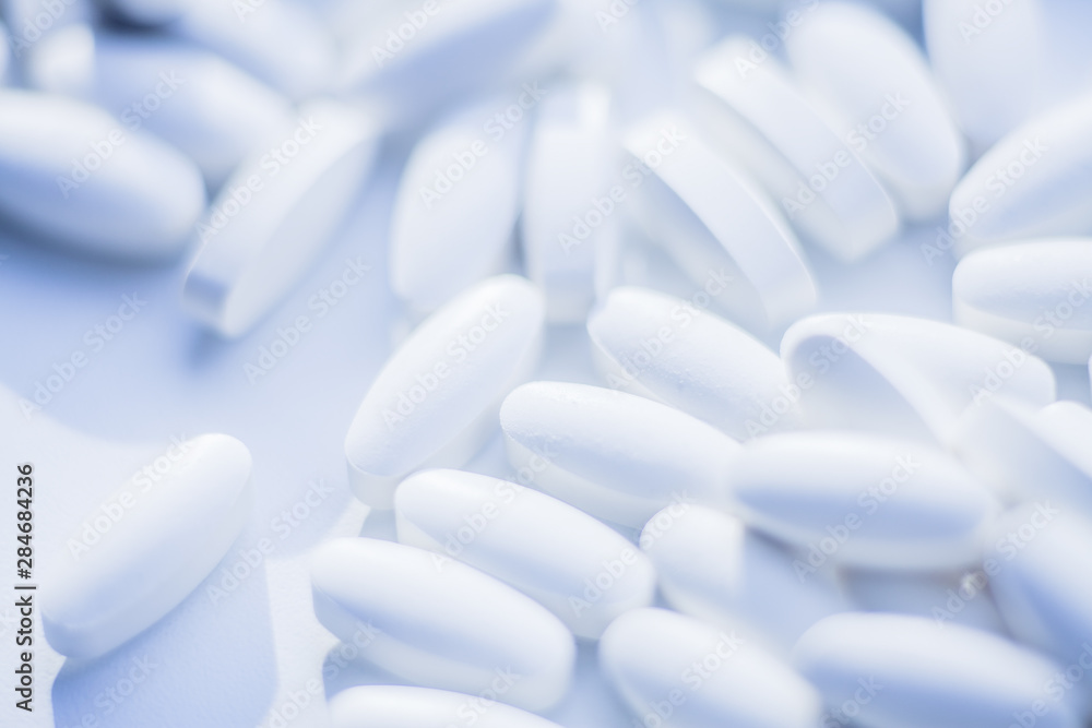White pills heap blured background White pills heap blured background