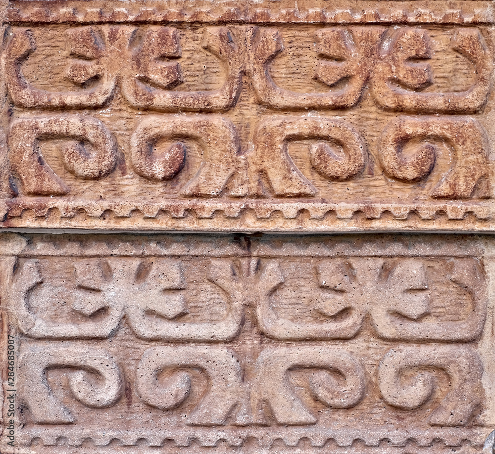 Arabesque oriental floral decorative design carved in stone wall. Arabesque oriental floral decorative design carved in stone wall.