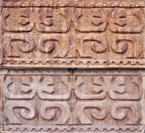 Arabesque oriental floral decorative design carved in stone wall.