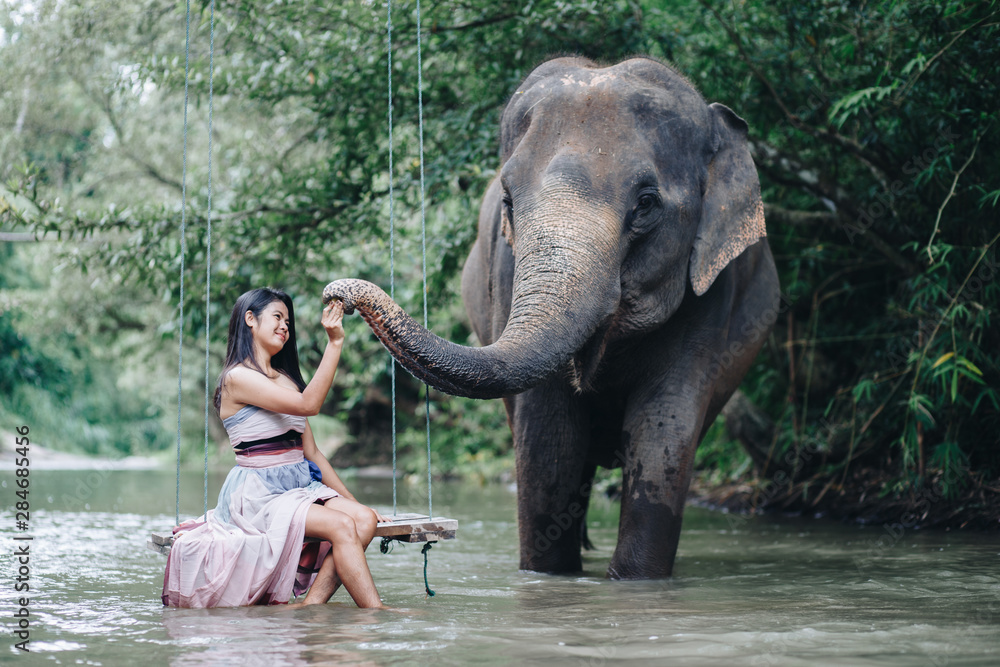 Fototapeta premium Portrait Asian woman enjoying with elephant