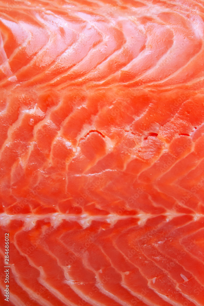 Fresh raw salmon fish textured fillet close up abstract background