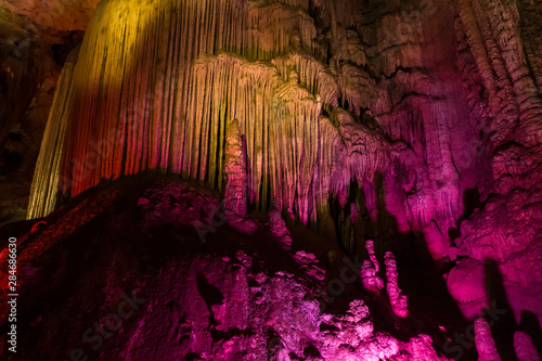 Colorful lighting of stalagmites in the cave of Prometheus  Georgia