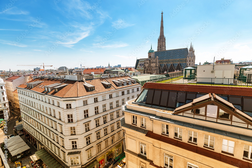 Aerial view of the roofs of houses and the main architectural attraction of Vienna - St. Stephen's Cathedral. Panorama of the city skyline