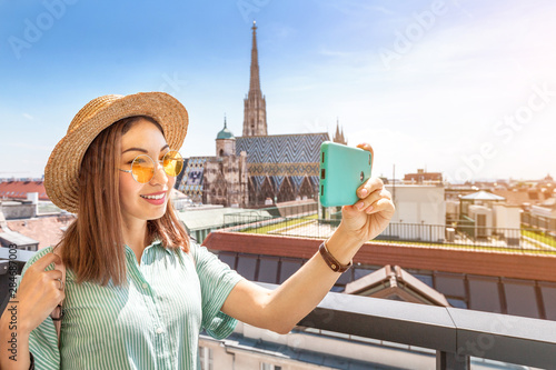 Canvas Print Young female asian tourist taking photo with Saint Stephen cathedral while trave