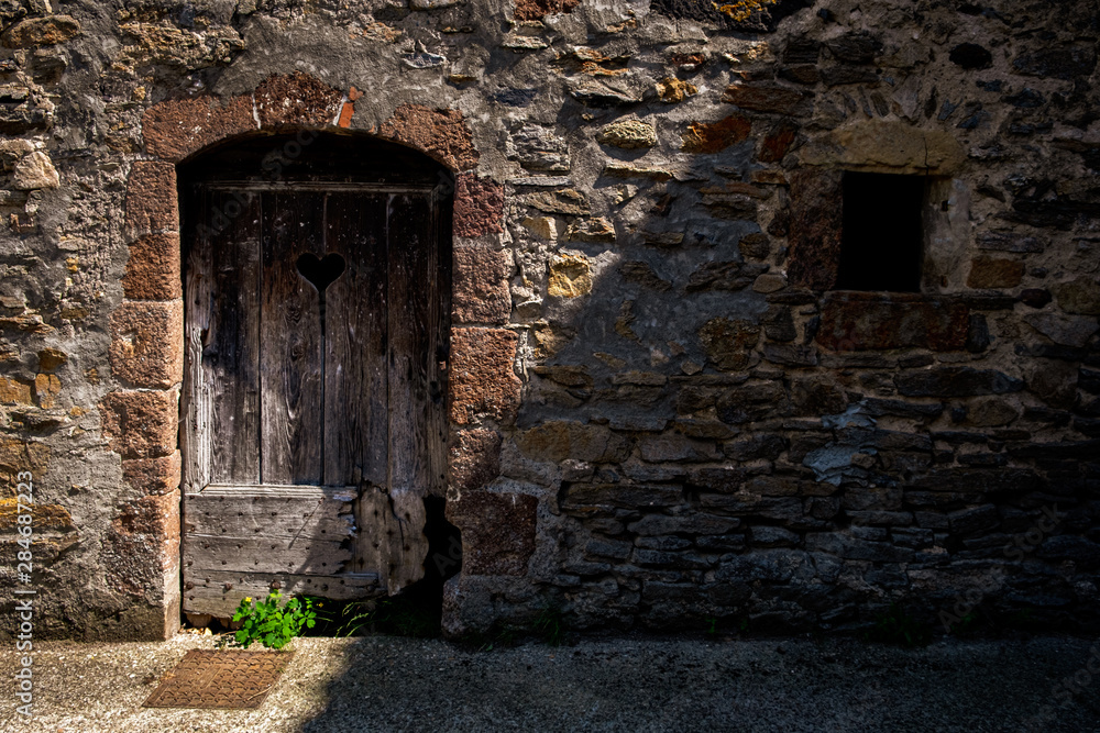 Obraz premium Door and window with heart in old french stone wall