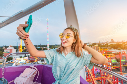 Photography Happy asian woman smiling and taking selfie photo on a ferris wheel