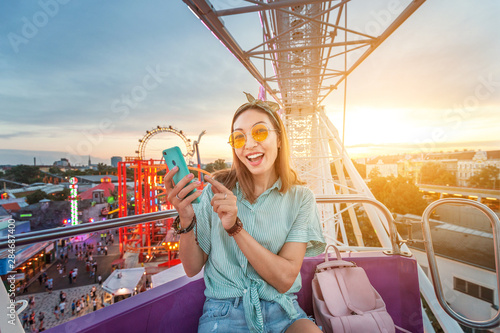 Photography Happy asian woman smiling and taking selfie photo on a ferris wheel