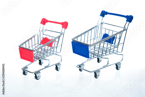 red and blue shopping cart figure on white background