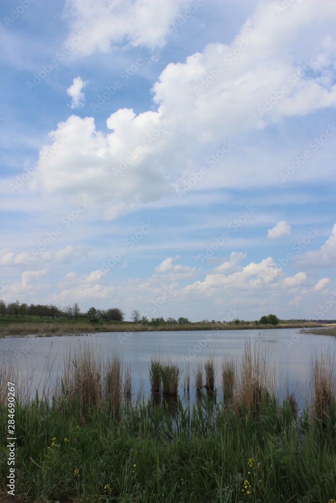 perfect country landscape with lake and clouds