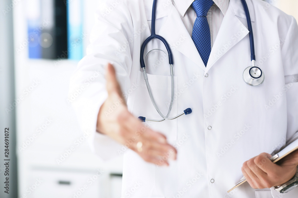 Male medicine doctor hold pad and give arm to shake in office closeup. Friend welcome introduction or thanks gesture. Work examine patient congratulation help exam teamwork deal concept. Male medicine doctor hold pad and give arm to shake in office closeup. Friend welcome introduction or thanks gesture. Work examine patient congratulation help exam teamwork deal concept.