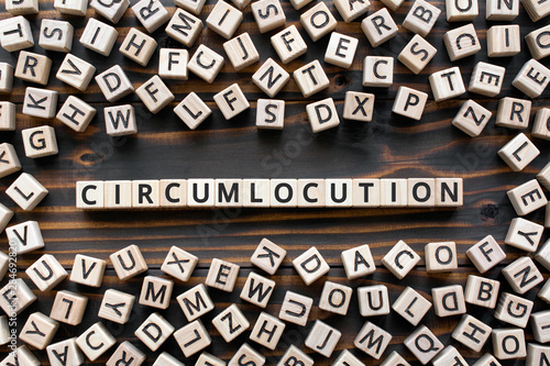 Circumlocution - word from wooden blocks with letters, an indirect way of saying something circumlocution allegory concept, random letters around, white  background