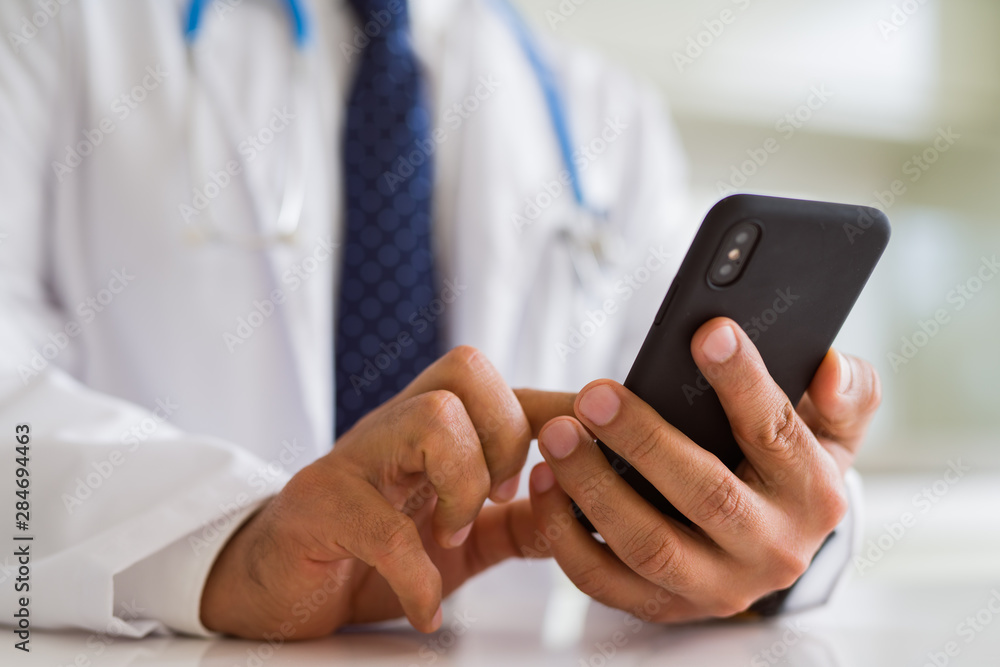 Close up middle age doctor man hands using smartphone Close up middle age doctor man hands using smartphone