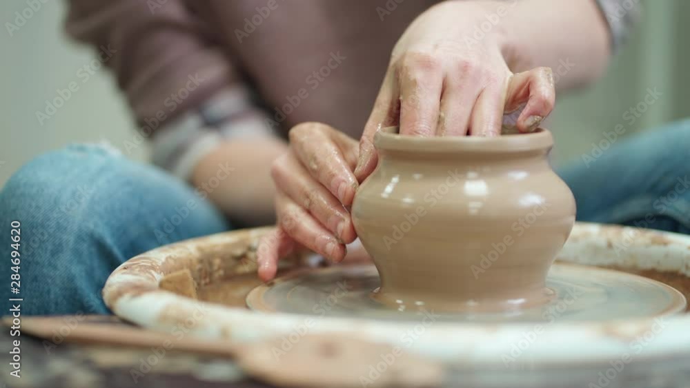 The formation of a clay pot with skillful hands of a master on a pottery wheel. The formation of a clay pot with skillful hands of a master on a pottery wheel.