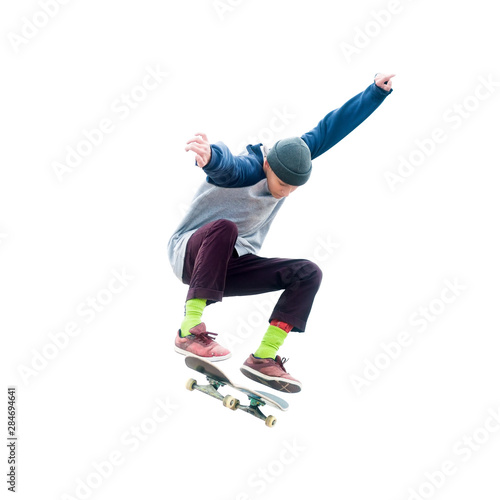 Teenager skateboarder jumps ollie on an isolated white background. The concept of street sports and urban culture