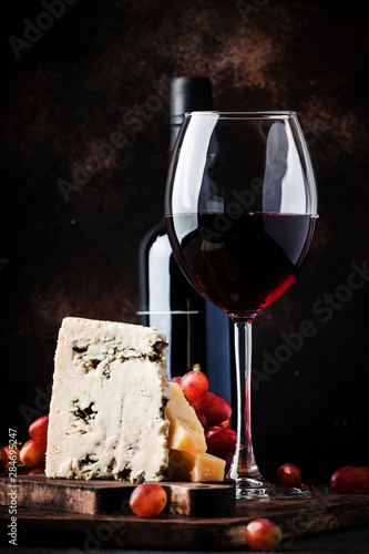 Port wine and blue cheese, still life in rustic style, vintage wooden table background, selective focus