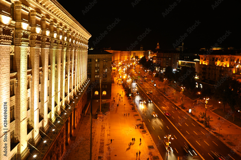 KYIV, UKRAINE - MAY 22, 2019: Beautiful view of illuminated Khreshchatyk street with road traffic and City Council building
