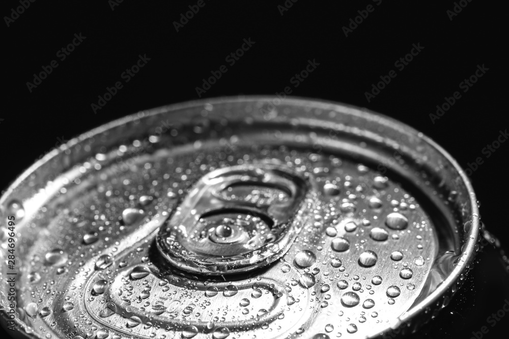 Aluminum can of beverage covered with water drops on black background, closeup Aluminum can of beverage covered with water drops on black background, closeup