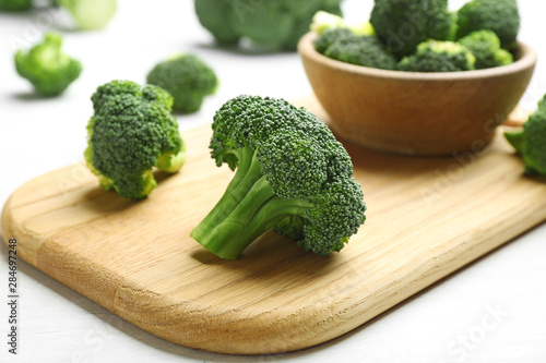 Composition with fresh broccoli on light table, closeup