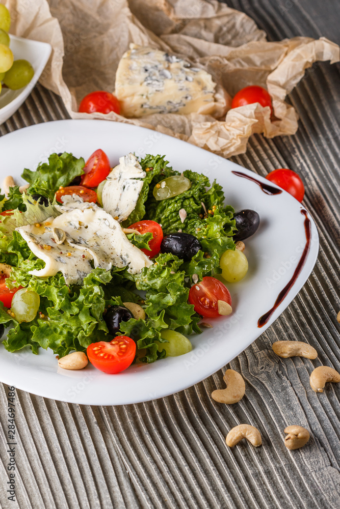 salad provence with blue cheese on wooden table salad provence with blue cheese on wooden table