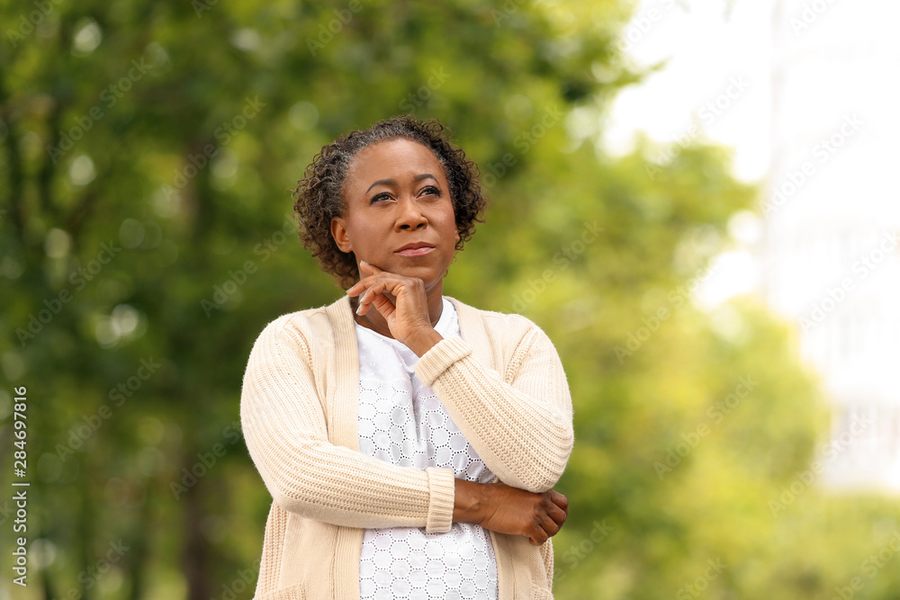 Portrait of happy African-American woman in park Portrait of happy African-American woman in park