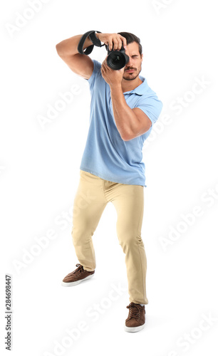 Young professional photographer taking picture on white background © New Africa