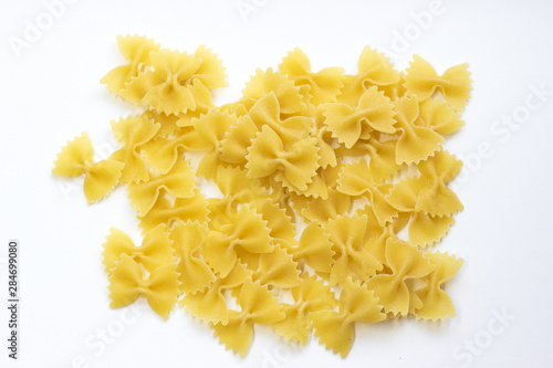 Group of yellow Farfalle shape of italian pasta on white background isolated