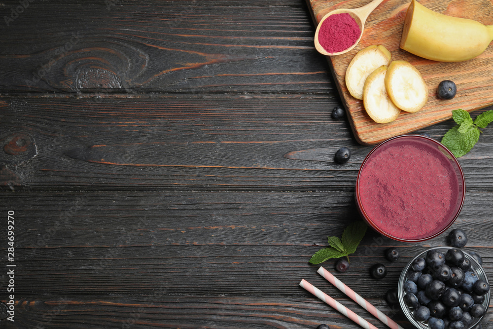 Fresh acai drink with berries and banana on dark wooden background, flat lay. Space for text Fresh acai drink with berries and banana on dark wooden background, flat lay. Space for text
