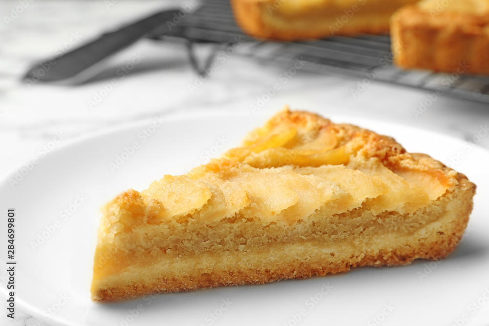 Piece of delicious sweet pear tart on table, closeup Piece of delicious sweet pear tart on table, closeup
