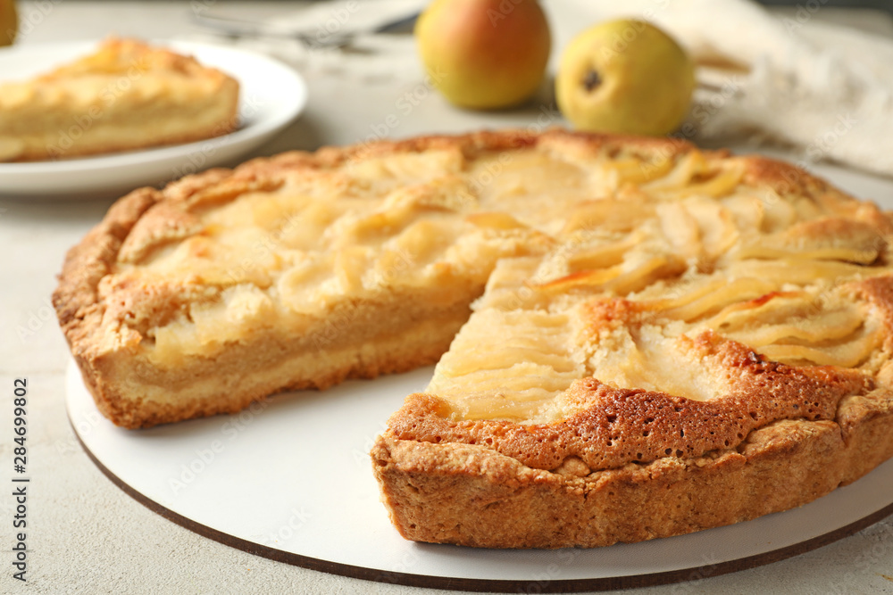 Cut delicious sweet pear tart on table, closeup Cut delicious sweet pear tart on table, closeup