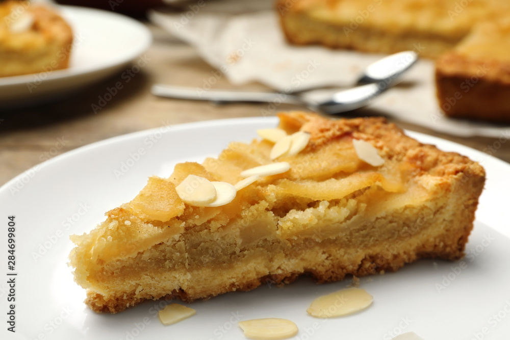 Piece of delicious sweet pear tart on table, closeup Piece of delicious sweet pear tart on table, closeup